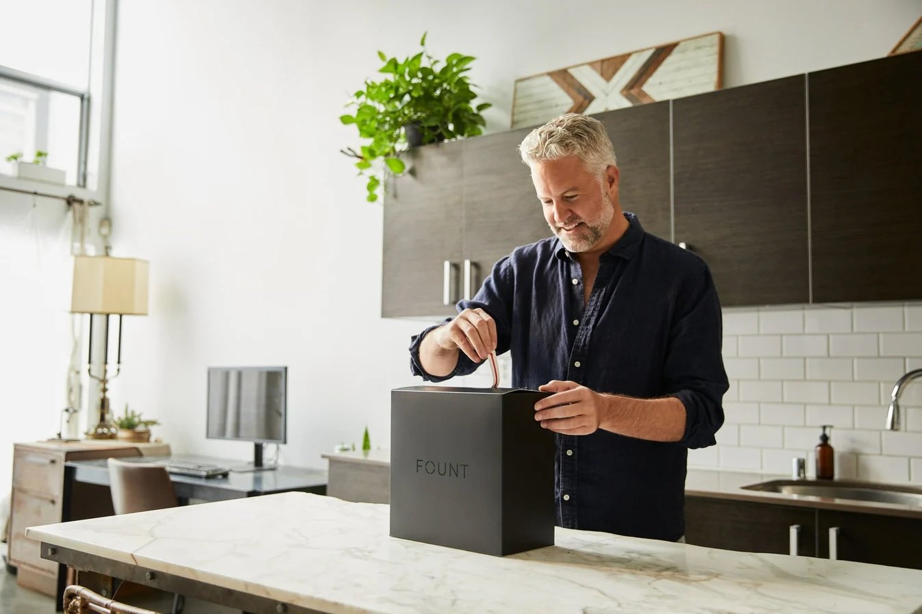 Unboxing the Fount branded box in a kitchen setting