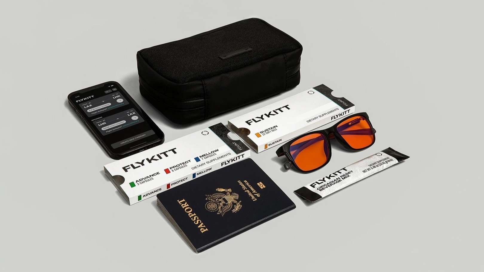 FlyKitt travel kit flat lay with packaging, app, and accessories