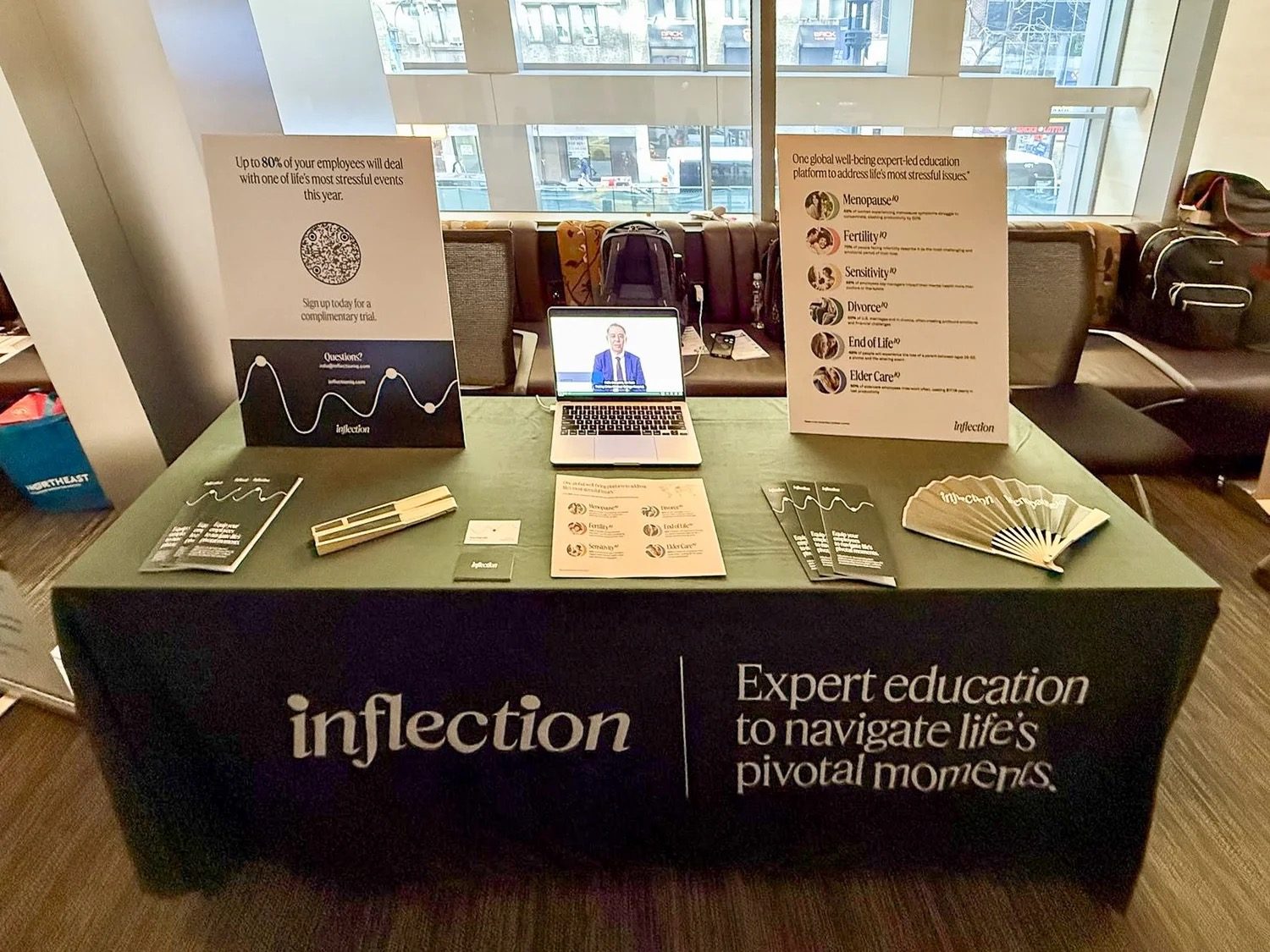 Inflection display kit with posters and handouts at a benefits event