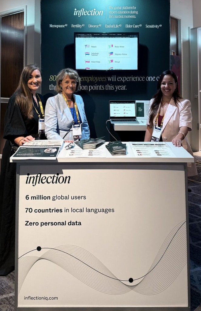 Inflection exhibition booth at the REBA conference with three team members